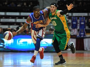 While driving the ball hard down the court, Flip White of the Harlem Globetrotters holds off a member of the Washington Generals at the Barrie Molson Center in Barrie, Ont. on Thursday, Feb. 5, 2015. The Generals are being cut from future appearances by the Globetrotters. (Mark Wanzel/Postmedia Network)