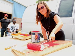 Kelsey Moore-Nielsen paints the smallest of 15 ramps during the first build day for the StopGap Sarnia-Lambton Community Ramp Project. The project supplies wooden ramps for single-step business entryways, to help make them more accessible. (Tyler Kula, The Observer)