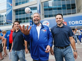 NDP Leader Tom Mulcair arrives at the Rogers Centre for the game between the Blue Jays and the Yankees with sons Greg and Matt  in on Aug. 14, 2015. Stan Behal/Toronto Sun)