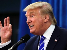 Republican presidential candidate Donald Trump gestures during a media availability prior to a campaign stop at Winnacunnet High School in Hampton, N.H., Friday, Aug. 14, 2015. (AP Photo/Charles Krupa)