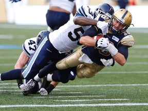 Winnipeg Blue Bombers' quarterback Robert Marve (16) dives in for the touchdown against Toronto Argonauts' Greg Jones (53) during the first half of CFL action in Winnipeg Friday, August 14, 2015. The touchdown was denied due to a holding penalty by Winnipeg. THE CANADIAN PRESS/John Woods