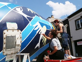 Tracy Baker, left, and Johanna Westby paint a mural on a cement truck on Durham Street in Sudbury, Ont. for Up Fest on Friday, August 14, 2015. The festival wraps up on Saturday. John Lappa/Sudbury Star/Postmedia Network