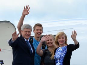 Conservative Leader Stephen Harper, wife Laureen and son and daughter Ben and Rachel wave as they arrive  in Quebec City for a rally while on the campaign trail on Sunday, August 9, 2015. Canadian's will head to the polls on Oct 19, 2015. THE CANADIAN PRESS/Sean Kilpatrick