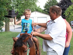 Stratton Matthew, 6, rides like a cowboy at the Bethel Bible Church Carnival in Seaforth.(Shaun Gregory/Huron Expositor)