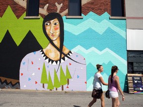 Festival-goers walk past a mural at Up Fest in Sudbury. (Ben Leeson/Sudbury Star file photo)