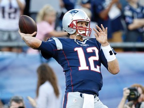 New England Patriots quarterback Tom Brady (12) throws a pass during warm-ups before the preseason game against the Green Bay Packers at Gillette Stadium. (Greg M. Cooper/USA TODAY Sports)
