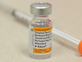 A bottle of the pertussis vaccine against whooping cough and a syringe are shown sitting on a counter in a pharmacy in this September 2010 file photo.  
AFP PHOTO FILES
