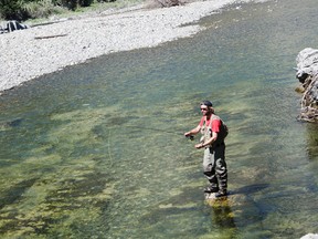 An angler casts a line into the Oldman River at The Gap where the river flows through the Livingstone Range in late July. Deteriorating water conditions result in increased stress levels for fish, increasing the risk of death even by catch-and-release anglers. As of Friday Aug. 14, the Oldman River from Highway 22 downstream to Secondary Road 510 was closed to fishing. John Stoesser photo/Pincher Creek Echo.