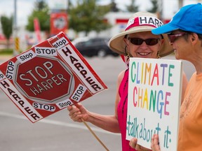 Mieke Thorne (left) and Jan Sosiak were two of about a dozen protesters at the corners of North Front Street and Bell Boulevard on Saturday August 15, 2015 in Belleville, Ont. The group, members of The Council of Canadians, were displaying their dissatisfaction with Prime Minister Stephen Harper.  Tim Miller/Belleville Intelligencer/Postmedia Network