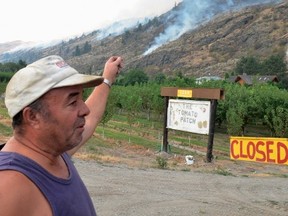 Spud Torrao talks about an aggressive wildfire near Oliver, B.C. on Aug. 15, 2015. (THE CANADIAN PRESS/Penticton Herald-Joe Fries)