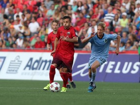 Saturday, Aug. 15, 2015 Ottawa -- Ottawa Fury FC midfielder Sinisa Ubiparipovic tries to get away from Minnesota United FC's Greg Jordan at TD Place on Saturday, August 15, 2015.(Chris Hofley/Ottawa Sun)