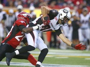 Stamps Jamar Wall (L) brings down RedBlacks' Brad Sinopoli during CFL action between the Calgary Stampeders and the Ottawa RedBlacks at McMahon Stadium in Calgary, Alta. on Saturday August 15, 2015. Jim Wells/Calgary Sun/Postmedia Network