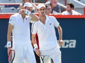 Daniel Nestor of Canada, left, speaks with teammate Edouard Roger-Vasselin of France in their match against Bob Bryan and Mike Bryan of USA during day seven of the Rogers Cup at Uniprix Stadium on August 16, 2015 in Montreal, Quebec, Canada. (Minas Panagiotakis/Getty Images/AFP)