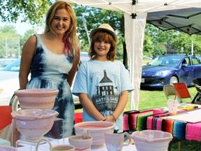 Young artists Kirsti Smith, on left, and Jane Marlo Nerenberg share a stand Women's Art Festival at City Park in Kingston on Sunday. (Steph Crosier/The Whig-Standard)