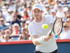 Andy Murray of Great Britain hits a return against Novak Djokovic of Serbia during day seven of the Rogers Cup at Uniprix Stadium on August 16, 2015 in Montreal, Quebec, Canada.   Minas Panagiotakis/Getty Images/AFP