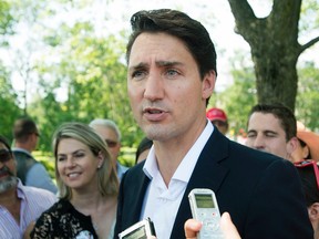 Liberal Leader Justin Trueau speaks to the media during a federal election campaign stop at the annual gay pride parade in Montreal, Sunday, August 16, 2015. THE CANADIAN PRESS/Graham Hughes