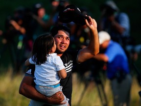 Jason Day of Australia walks off the 18th green with his son Dash after winning the 2015 PGA Championship with a score of 20-under par at Whistling Straits on August 16, 2015 in Sheboygan, Wisconsin.   Kevin C. Cox/Getty Images/AFP