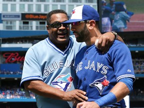 Former Blue Jays outfielder George Bell (left), who was part of a pre-game ceremony Sunday at the Rogers Centre, chats with current right fielder Jose Bautista. (CRAIG ROBERTSON/Toronto Sun)