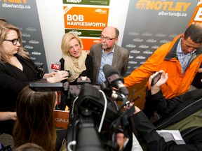 Premier Rachel Notley and NDP candidate Bob Hawkesworth speak with media at Edgepointe Village in Calgary, Alta., on Sunday, Aug. 16, 2015. Notley was helping Hawkesworth launch his campaign for the Calgary-Foothills byelection, a seat made vacant when former premier Jim Prentice quit his post after the Tories lost the last election. Lyle Aspinall/Calgary Sun/Postmedia Network
