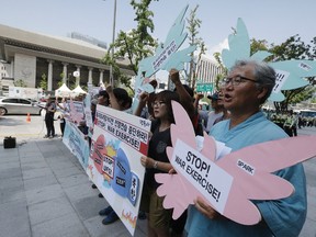 South Korean protesters shout slogans during a rally demanding to stop the joint military exercises, Ulchi Freedom Guardian or UFG, between the U.S. and South Korea near the U.S. Embassy in Seoul, South Korea, on Aug. 17, 2015. (AP Photo/Ahn Young-joon)