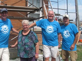 Christina Desjardins, second from left, was overjoyed as her home on Jeffrey Street in Chatham was getting a makeover from the Backyard Mission project on Aug. 14-15. Also pictured, from left, are Rev. Mike Maroney of First Presbyterian Church, Pastor Jack Kerkhof from First Christian Reformed Church and contractor Mark Labadie of Mark Labadie Construction.