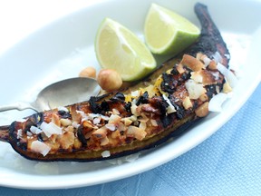This Aug. 3, 2015 photo shows grilled tropical plantains in Concord, N.H. These grilled tropical plantains get their richness from coconut oil, unsweetened coconut and macadamia nuts. Since this recipe takes just minutes to make, these are perfect for entertaining. (AP Photo/Matthew Mead)