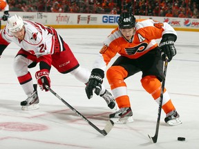 Danny Briere #48 of the Philadelphia Flyers heads for the net as Bobby Sanguinetti #24 of the Carolina Hurricanes defends on February 2, 2013 at the Wells Fargo Center in Philadelphia, Pennsylvania. (Elsa/Getty Images/AFP)