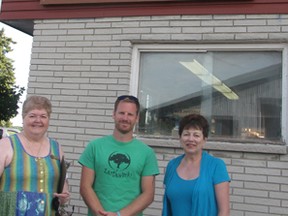 Joyce Martin-Bruce, president of the Chatham-Kent Quilters Guild, Derek Shepherd of Earthworks garden centre, and Heather Loucks, chair of the barn quilt trail committee, stand under a barn quilt that was attached to the Earthworks building on Saturday. “The Tree of Life” quilt was the first to be installed for the new barn quilt trail in Chatham-Kent. Picture taken on Saturday, August 15, 2015.