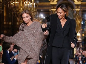 Models Cara Delevingne (L) and Joan Smalls (R) present creations by British designer Stella McCartney as part of her Fall/Winter 2014-2015 women's ready-to-wear collection show during Paris Fashion Week, in this March 3, 2014 file photo. REUTERS/Benoit Tessier/Files