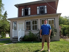 Jason Magee stands in front of  a home on Grier Street that caught fire early Sunday morning. He and Kevin James, another Belleville resident, helped rescue a man who was unconscious on the stairs inside the home Sunday. 
Sarah Hyatt/Belleville Intelligencer/Postmedia Network