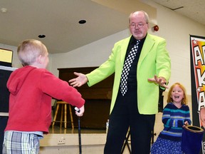 Cole Templeman (left) shows magician Peter Mennie that the wand he had given him was not working as planned, as Reina Nevin - Templeman's temporary assistant - can't contain her laughter, during the magic show held at the Mitchell & District Community Centre last Wednesday, Aug. 12. GALEN SIMMONS/MITCHELL ADVOCATE