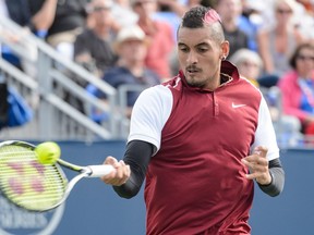 Nick Kyrgios of Australia hits a return against John Isner of the USA during day four of the Rogers Cup at Uniprix Stadium on August 13, 2015 in Montreal, Quebec, Canada.   Minas Panagiotakis/Getty Images/AFP
