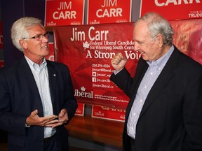 Winnipeg South Centre Liberal candidate Jim Carr (left) shares a moment with former prime minister Paul Martin during a stop at Carr's campaign office on Monday. (Brian Donogh/Winnipeg Sun)