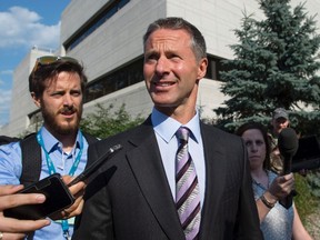 Nigel Wright, centre, former Chief of Staff to Prime Minister Stephen Harper, leaves the courthouse in Ottawa following his fourth day of testimony at the trial of former Conservative Senator Mike Duffy on Monday, August 17, 2015. Duffy is facing 31 charges of fraud, breach of trust and bribery. THE CANADIAN PRESS/Justin Tang