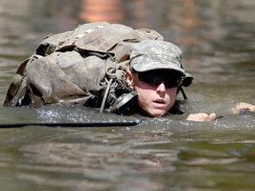 A female Army Ranger student crosses the Yellow River on a rope bridge on Tuesday, Aug. 4, 2015, at Camp James E. Rudder on Eglin Air Force Base, Fla. Two females have made history by becoming the first women to pass the elite U.S. Army's Ranger Course. Nick Tomecek/Northwest Florida Daily News via AP