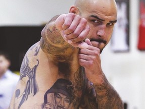 Centre Robert Sacre shows off his tattoos and some of his boxing skills on Monday at practice. (CRAIG ROBERTSON/Toronto Sun)