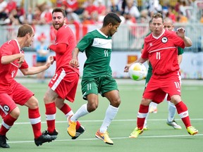 Brazil forward Jan Brito Da Costa (11) moves the ball past Canadians John Phillips, left, Matt Gilbert, second left, and Matt Brown, right, during first half Football-7 at the Parapan American Games in Toronto last Wednesday. THE CANADIAN PRESS/Nathan Denette