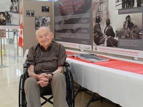 Edward Switocz, a former fighter with the Polish Home Army, views an exhibition honouring Canada's contribution to the Warsaw Uprising of 1944. The traveling exhibition will be in Sarnia during the month of August. 
CARL HNATYSHYN/SARNIA THIS WEEK