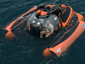 Russian President Vladimir Putin, right, sits on board a bathyscaphe as it plunges into the Black sea along the coast of Sevastopol, Crimea, Tuesday, Aug. 18, 2015. President Vladimir Putin plunged into the Black Sea to see the wreckage of a sunk ancient merchant ship which was found in the end of May. (Alexei Nikolsky/RIA-Novosti, Kremlin Pool Photo via AP)