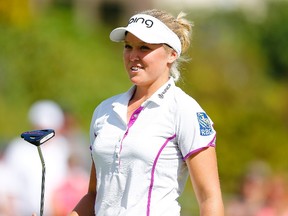 Brooke Henderson of Canada smiles on the 18th hole after shooting 18 under par for the tournament during the third round of the LPGA Cambia Portland Classic at Columbia Edgewater Country Club on August 15, 2015. (Jonathan Ferrey/Getty Images/AFP)
