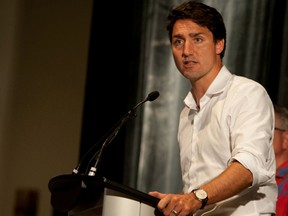 Liberal leader Justin Trudeau speaks at a party rally in Meadow Lake, Saskatchewan, with Regina-Wascana MP Ralph Goodale and candidates Lawrence Joseph for Desnethe Missinippi-Churchill River and Battlefords-Lloydminster candidate Larry Ingram at his side on August 12, 2015. James Wood/Lloydminster Meridian Booster/Postmedia Network