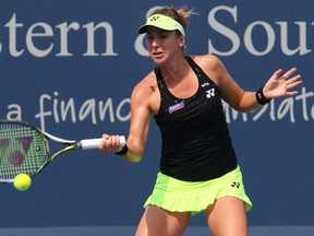 Belinda Bencic returns the ball to Angelique Kerber during the Western & Southern Open Tuesday, Aug. 18, 2015, in Mason, Ohio. (AP Photo/Tom Uhlman)