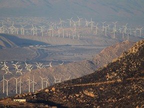 Wind turbines are seen in the distance beyond hills near Banning, California in this file photo from August 8, 2013. (REUTERS/David McNew)