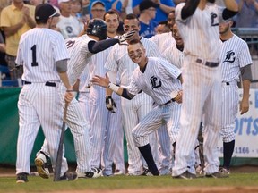 The London Majors wait to congratulate Michael Ambrose after the catcher scored a home run during the second game of their Intercounty Baseball League playoff series against the Kitchener Panthers at Labatt Memorial Park in London, Ont. on Tuesday August 18, 2015. (CRAIG GLOVER, The London Free Press)