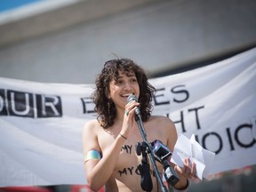 Tameera Mohamed speaks at the Bare With Us Rally in Waterloo Aug. 1, 2015. Tameera Mohamed and her two sisters Nadia Mohamed and Alysha Brilla were recently cycling topless when a police officer told them to cover up. The three of them organized the Bare With Us rally to help raise awareness about women's rights. (THE CANADIAN PRESS/Hannah Yoon)