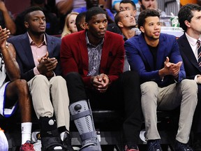 Philadelphia 76ers’ Jerami Grant, left, Joel Embiid, middle, and Michael Carter-Williams, right, watch from the bench during a preseason game against the Charlotte Hornets in Philadelphia. (AP Photo/Michael Perez, File)