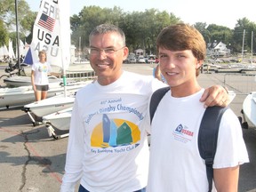 Andy Burwell, left, and his son Chase, from Clearwater, Fla., are in Kingston on for a sailing regatta. Burwell and his son have travelled around North America this summer going from regatta to regatta. (Michael Lea/The Whig-Standard)