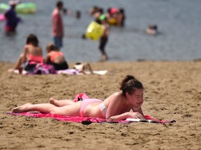 People keep cool at Mooney's Bay Beach during a heatwave in Ottawa on Sunday, Aug. 16, 2015. Environment Canada issued a heat warning for Ottawa, with temperatures around 30 C, feeling like 40 C with the humidex. THE CANADIAN PRESS/Justin Tang
