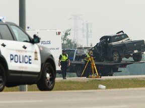 Edmonton Police Service officers investigate a fatal single vehicle crash on Anthony Henday Drive north of the 101 Avenue interchange in Edmonton, Alta., on Saturday July 11, 2015. Police say the the 47-year-old driver crossed the centre boulevard while traveling at high speed before colliding with an overhead sign. Ian Kucerak/Edmonton Sun