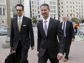 Nigel Wright, centre, former chief of staff to Canadian Prime Minister Stephen Harper, arrives at the courthouse in Ottawa, Canada August 19, 2015. (REUTERS/Chris Wattie)